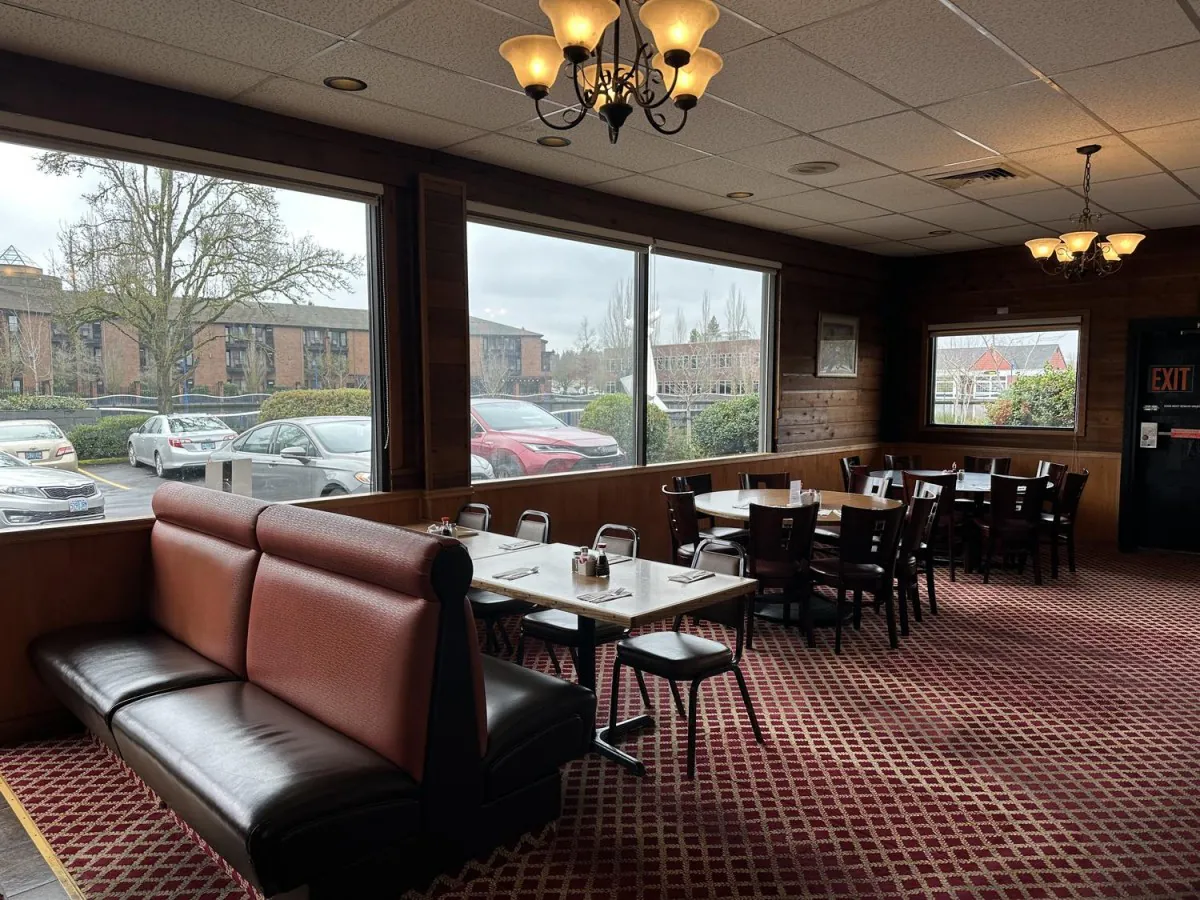 interior with a traditional Chinese landscape mural on the wall, brown leather booths, red checkered carpet at Lee's Kitchen，a Chinese Restaurant in Tualatin